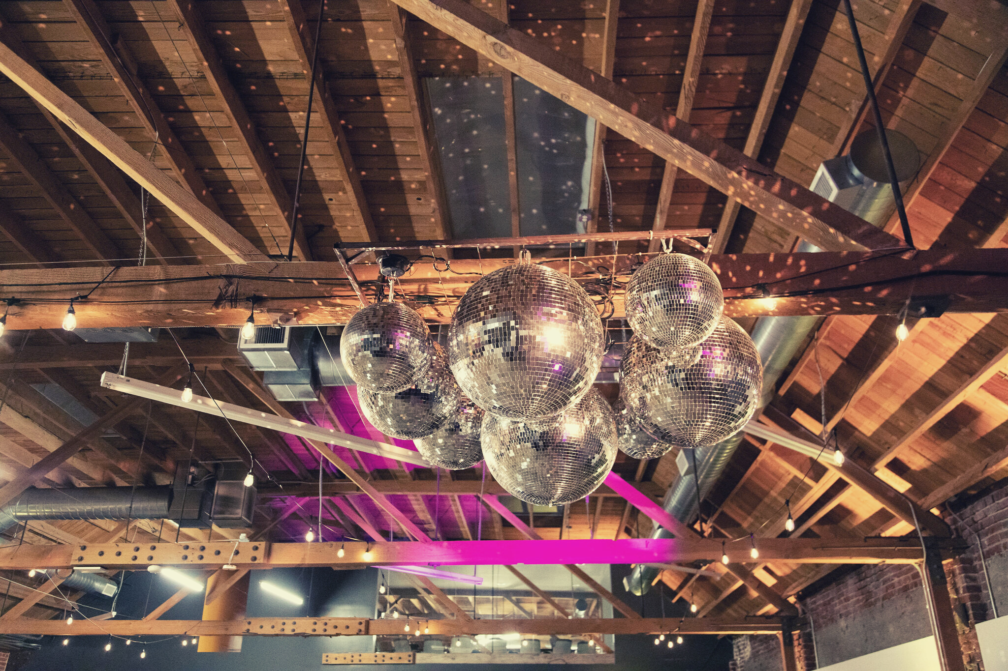 MG Studio Wedding Event Space Downtown Los Angeles Renovated Warehouse Exposed Brick Wood Beams Concrete Modern Industrial Chic - Disco Ball Chandelier
