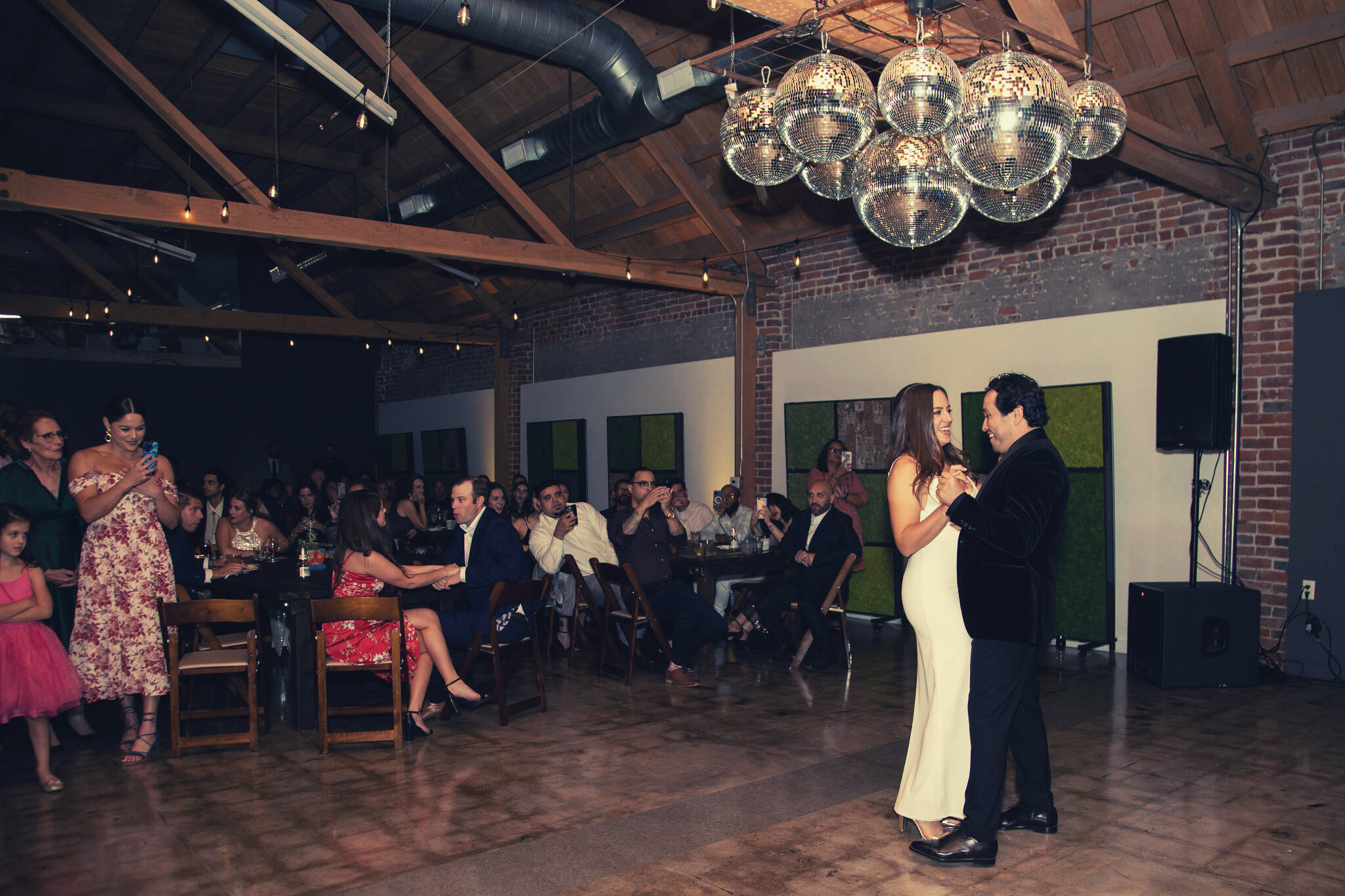 MG Studio Wedding Event Space Downtown Los Angeles Renovated Warehouse Exposed Brick Wood Beams Concrete Modern Industrial Chic - First Dance Happy Couple