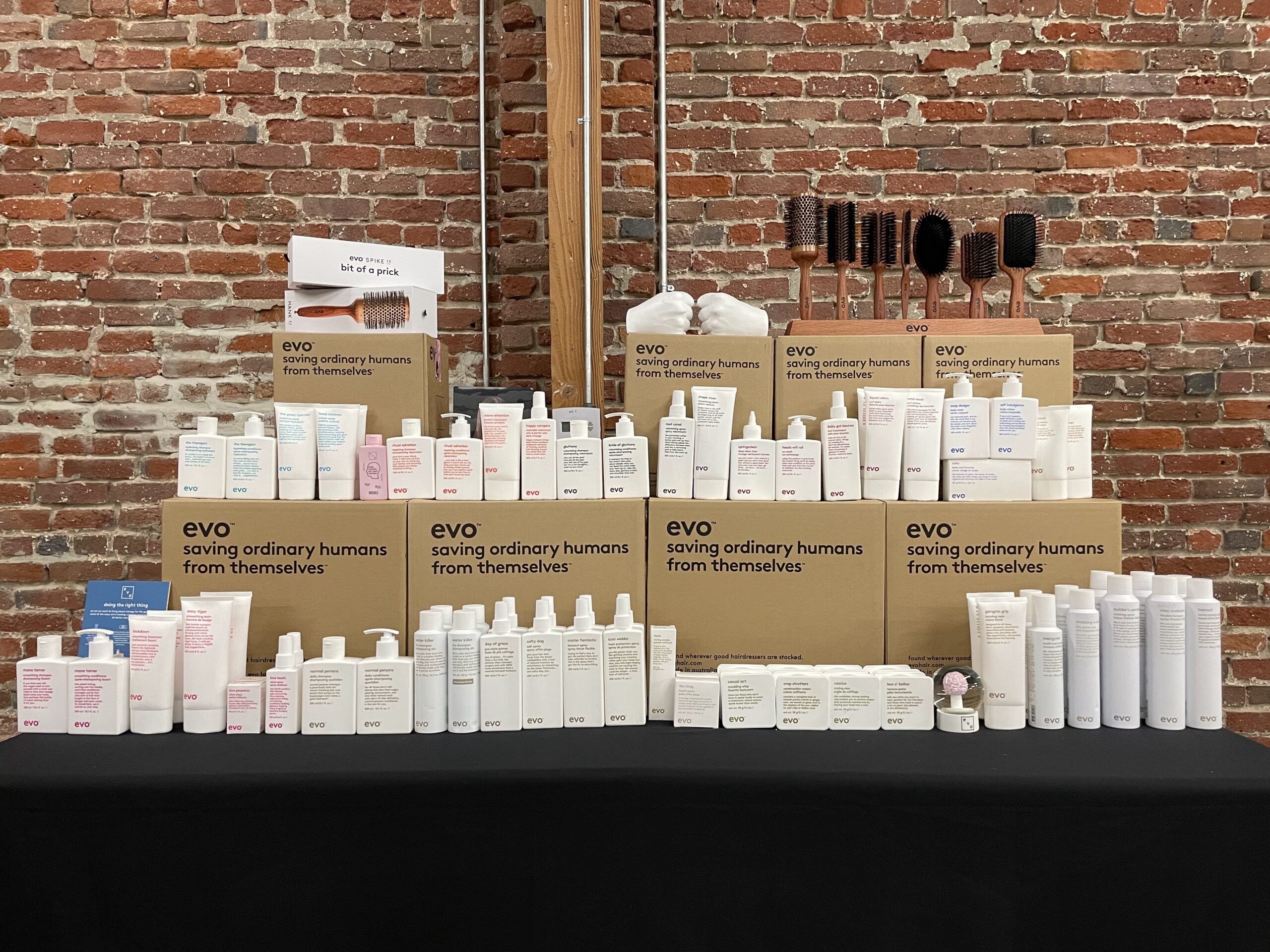evo hair training event at MG Studio full product line up against brick wall