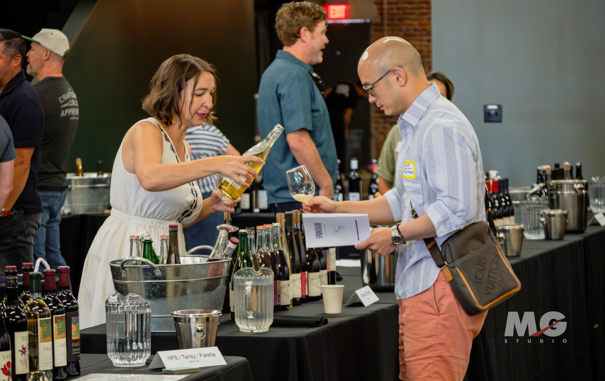 Tasting Event at MG Studio - pouring wine for guest