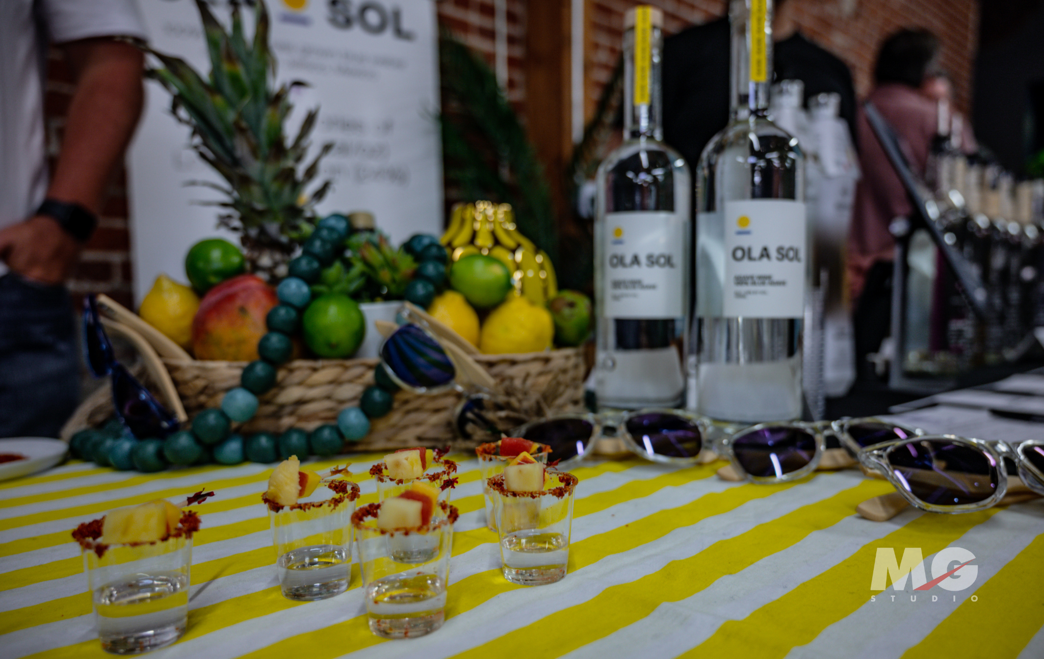Tasting Event at MG Studio - Ola Sol spirits with shot glasses and fruit garnish