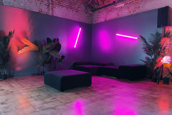Corner lounge at MG Studio event space neon walls
